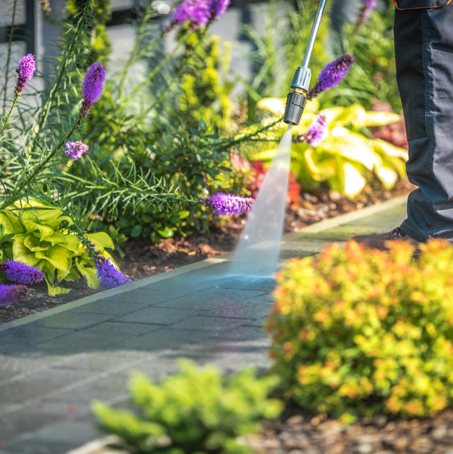 Pressure washing garden walkway.